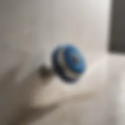 Close-up view of a bathroom spin scrubber in action on a tiled wall