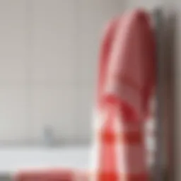 Elegant soft pink bath towel draped over a modern bathroom rack