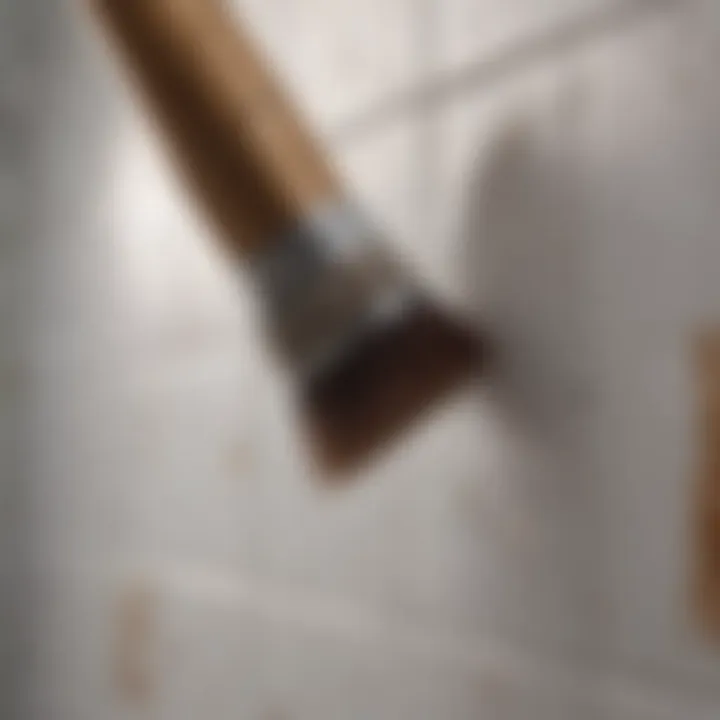 A close-up of a brush applying paint to ceramic tiles