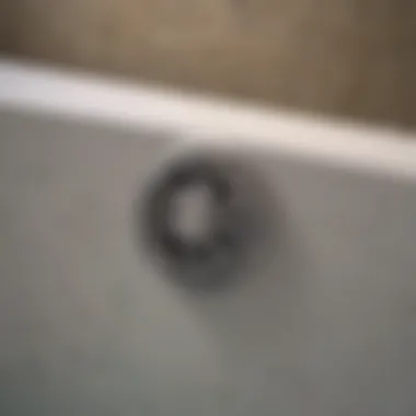 Close-up view of a bathtub drain showing signs of odor-causing buildup.